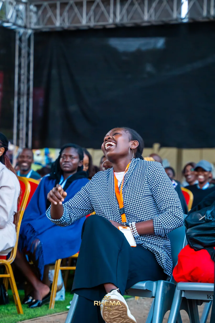 The same delegate mid-laugh, hand lifted