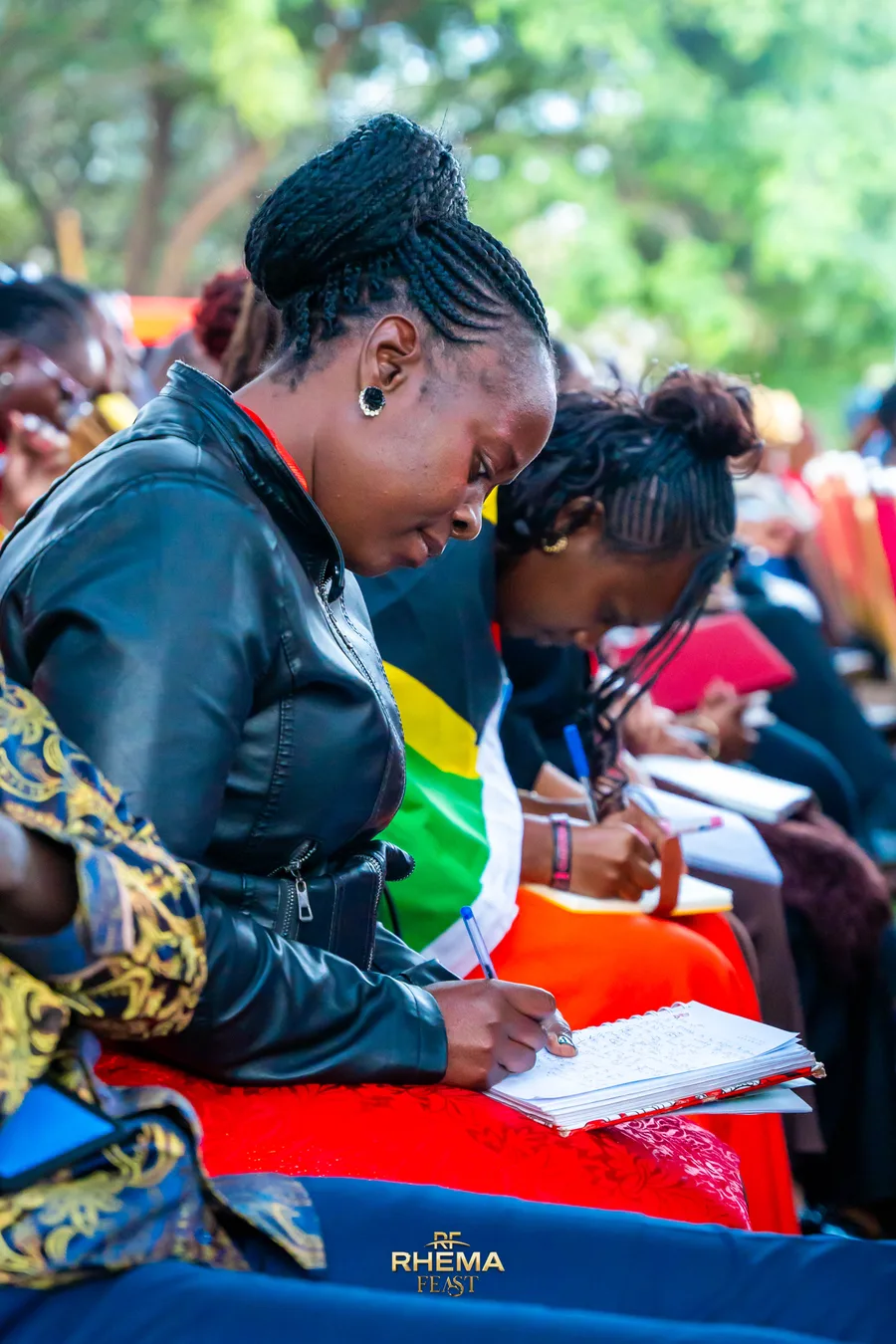 A delegate writing in a notebook during the session