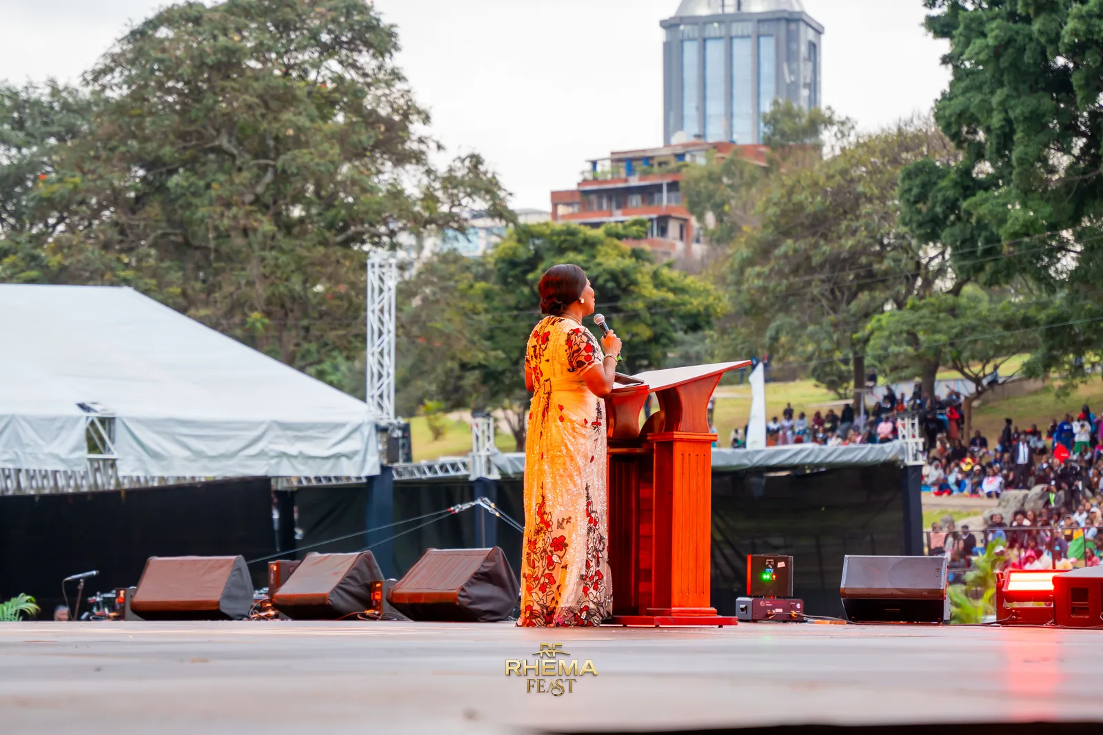 Bishop Funke Felix-Adejumo at the lectern, the park and the Nairobi skyline beyond