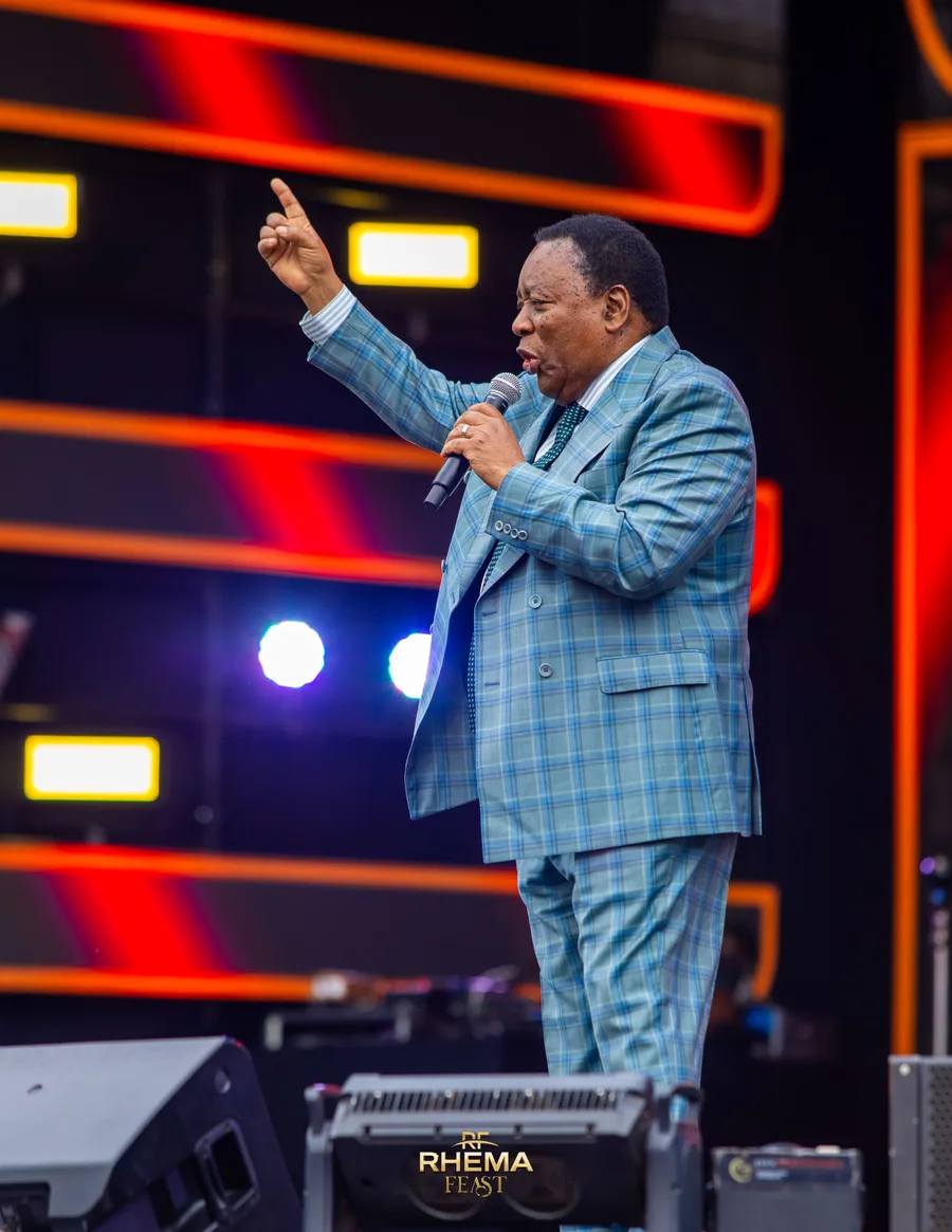 Bishop J.B. Masinde with one hand raised, mid-sentence