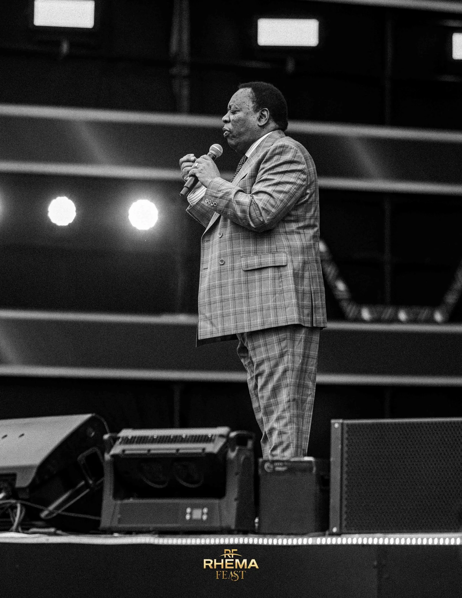Bishop J.B. Masinde preaching, lit against a dark stage