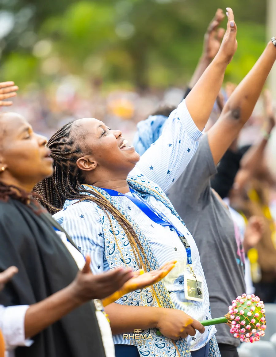 Two women worshipping with their faces lifted