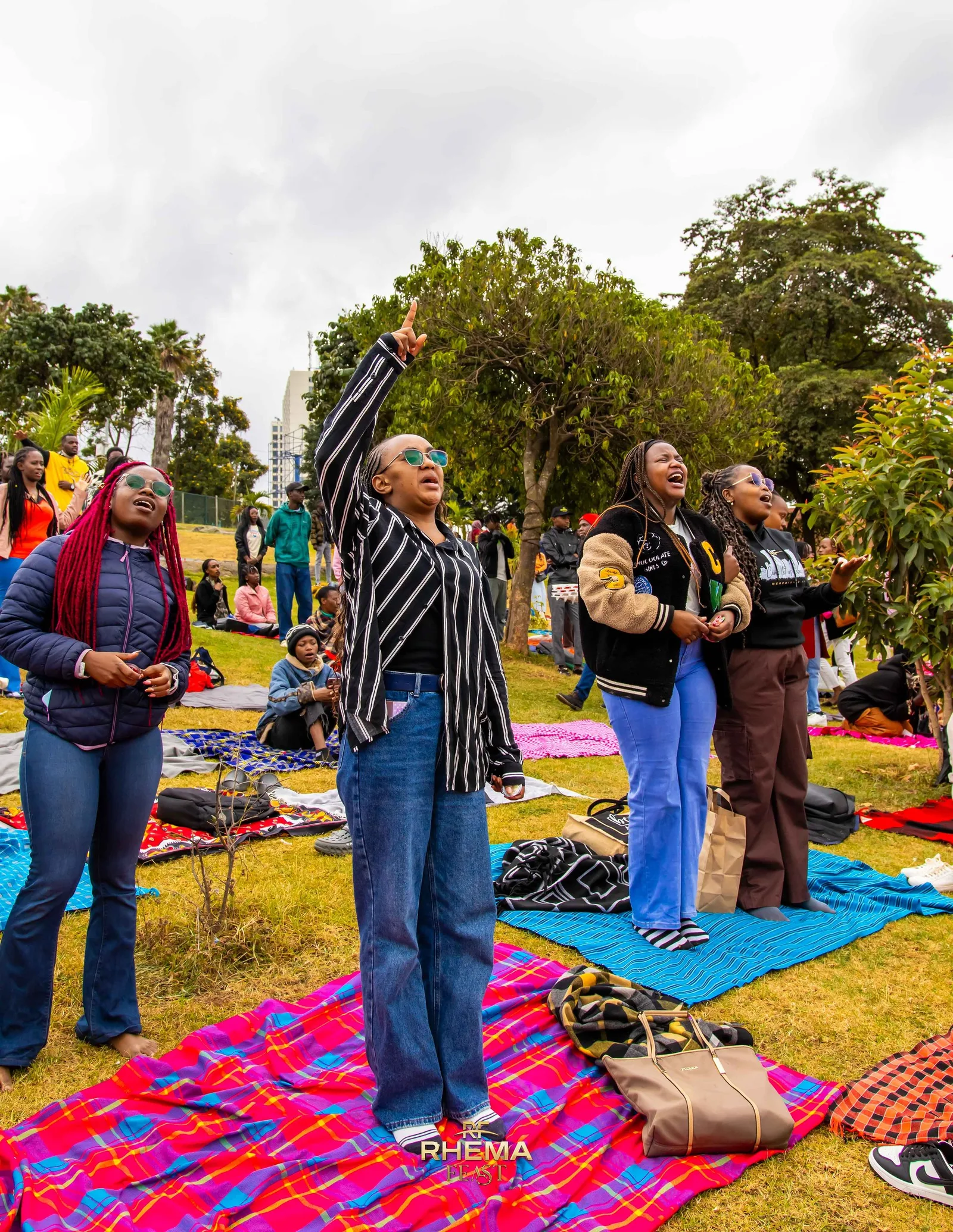 Delegates kneeling on mats at Uhuru Park during the Day of Prayer