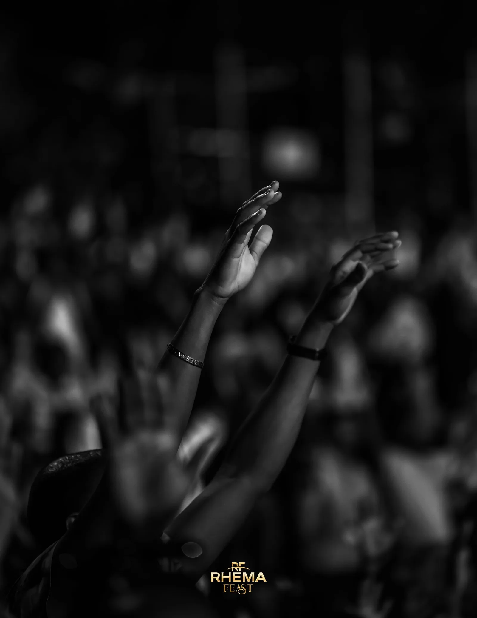 A worshipper's hand raised in silhouette against the sky