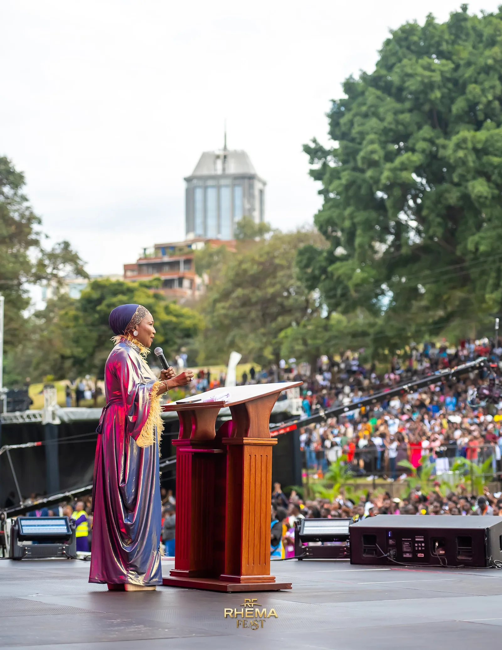 Bishop Funke Felix-Adejumo at the podium, the crowd filling the frame behind her