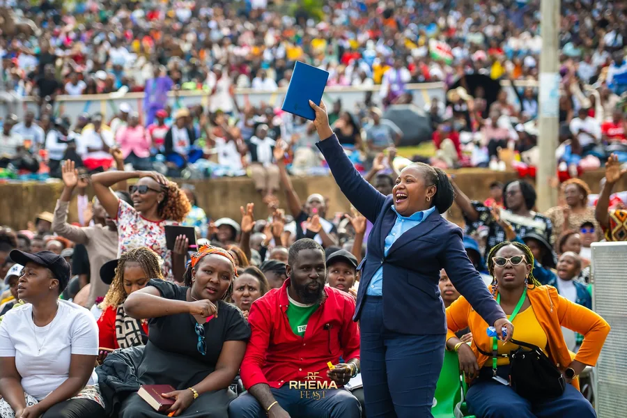 A delegate holding up a book in the crowd