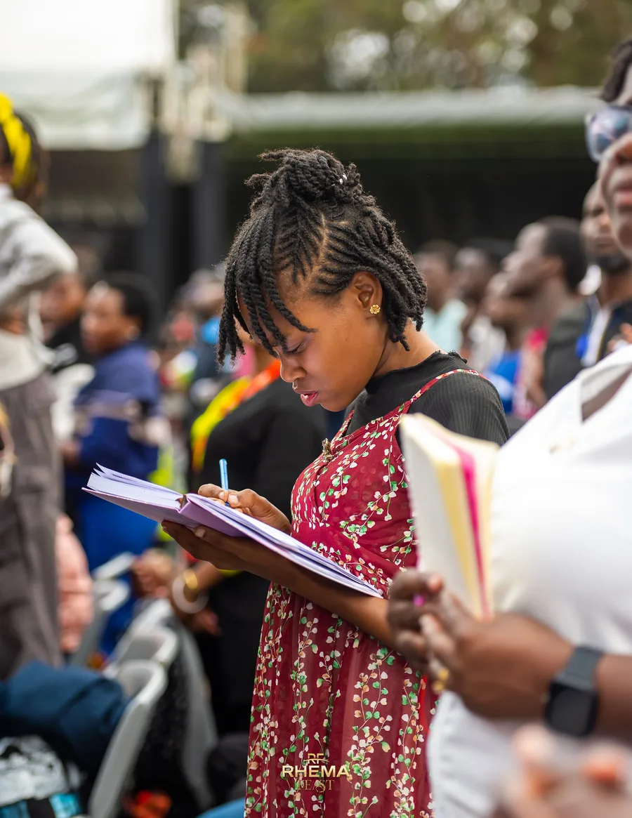 A delegate writing in a notebook during the session
