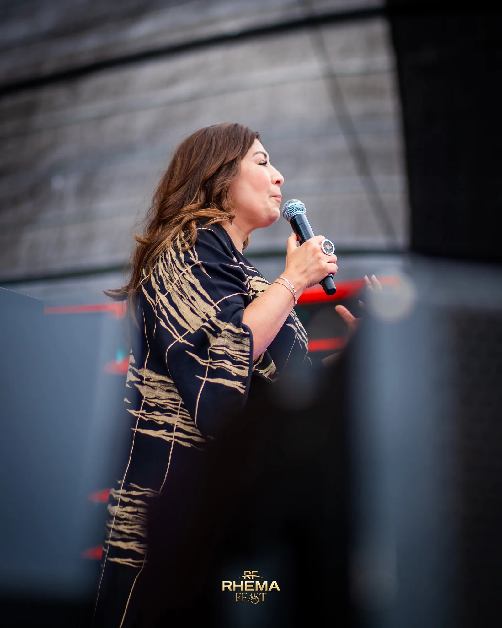 Rev Laura leading prayer at Rhema Feast 2026