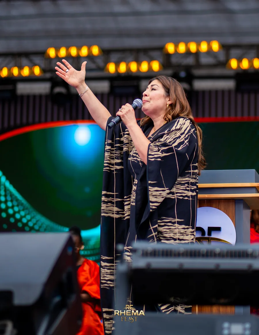 Rev Laura leading the Day of Prayer session, hand raised