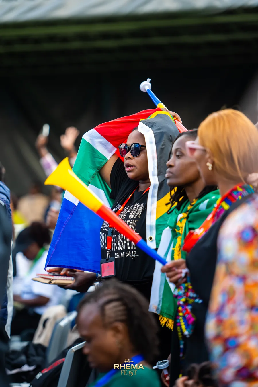 Delegates in the crowd with South African flags and vuvuzelas