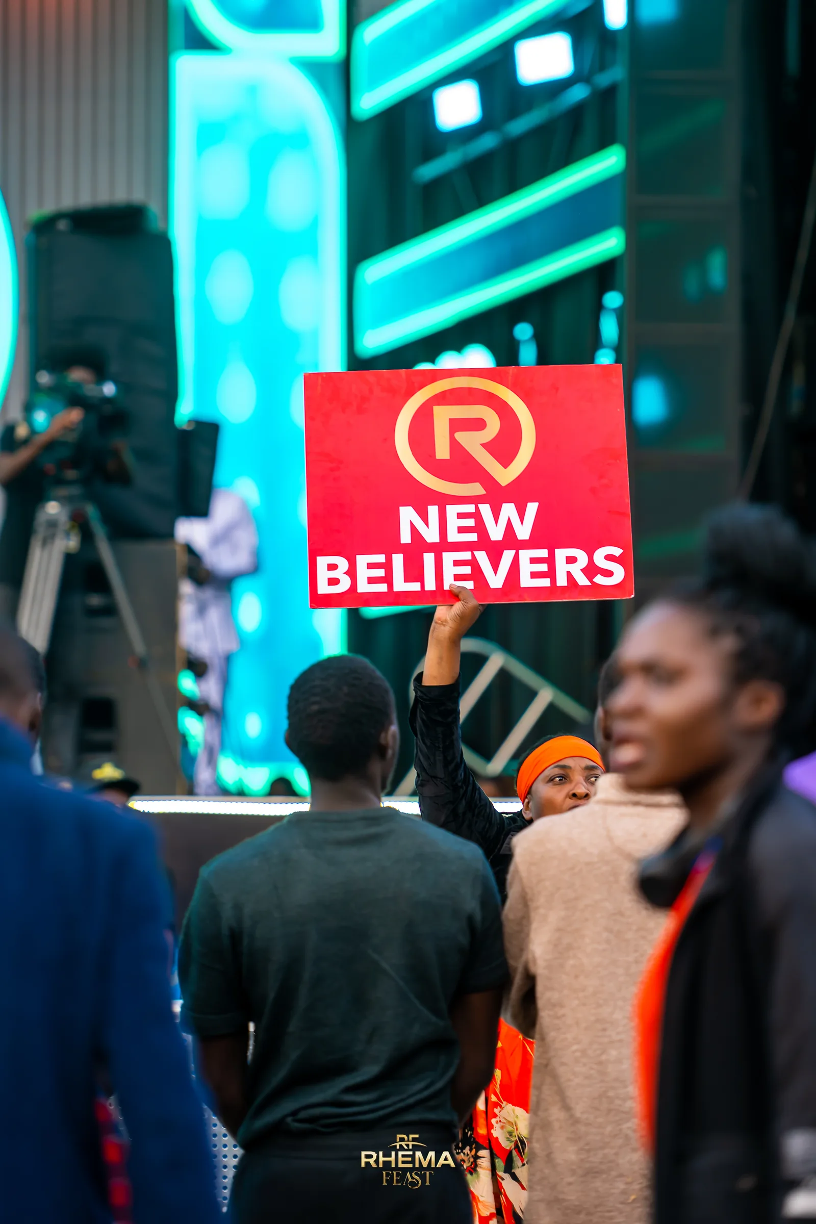 The New Believers placard raised in the crowd on Day 3