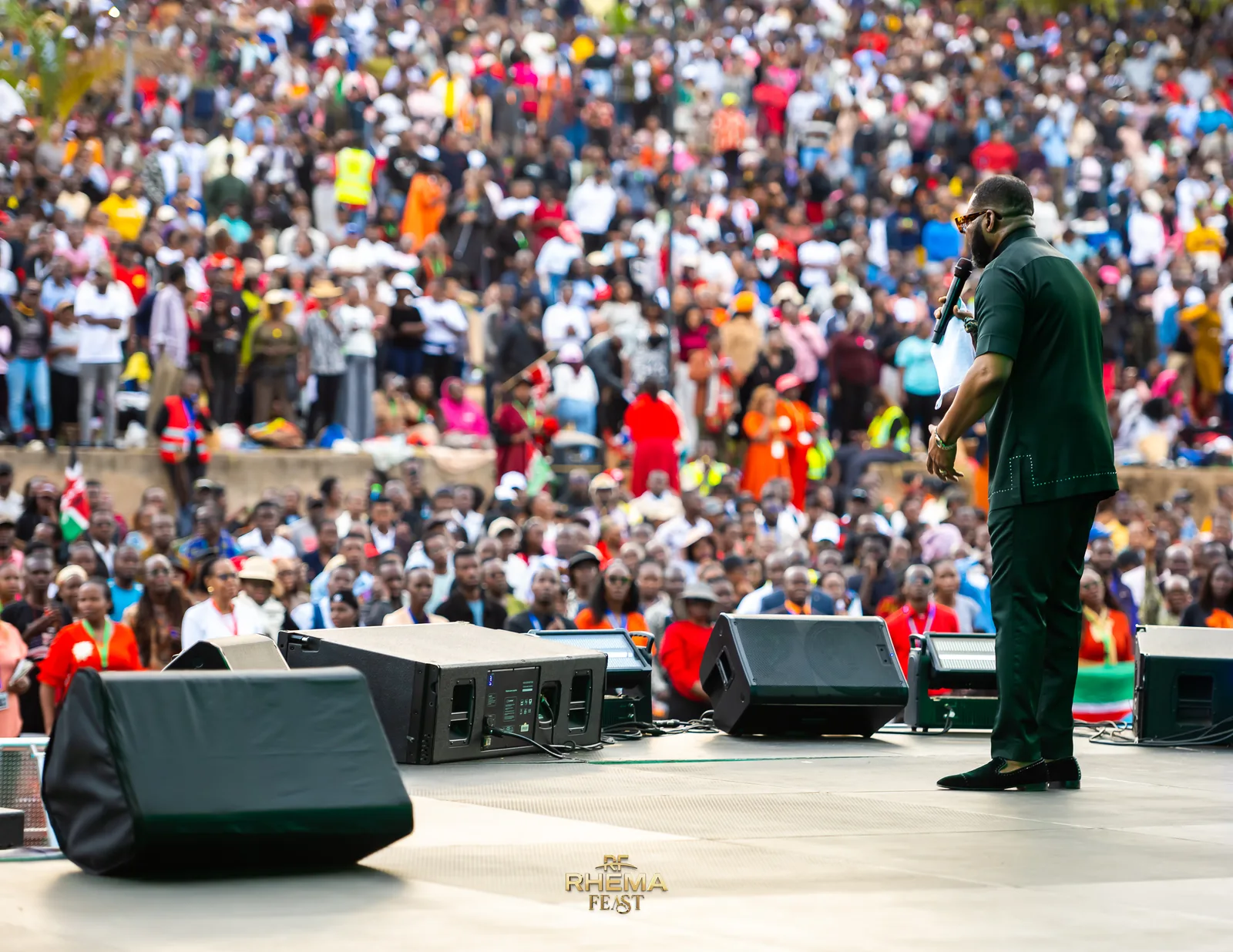 Felix Okoh on the stage edge, preaching to the field at Uhuru Park