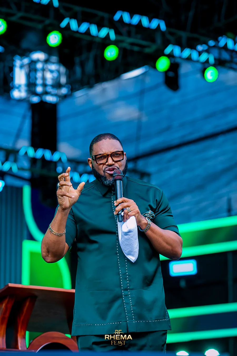 Felix Okoh making a point, both hands raised