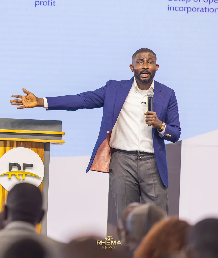 Seyi Ebenezer mid-keynote, both arms open