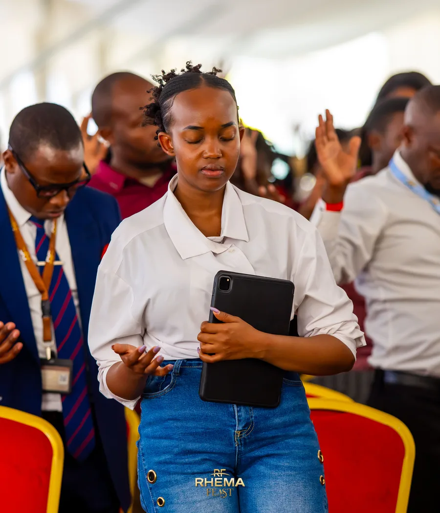 A delegate at Tech Talk with a tablet, listening