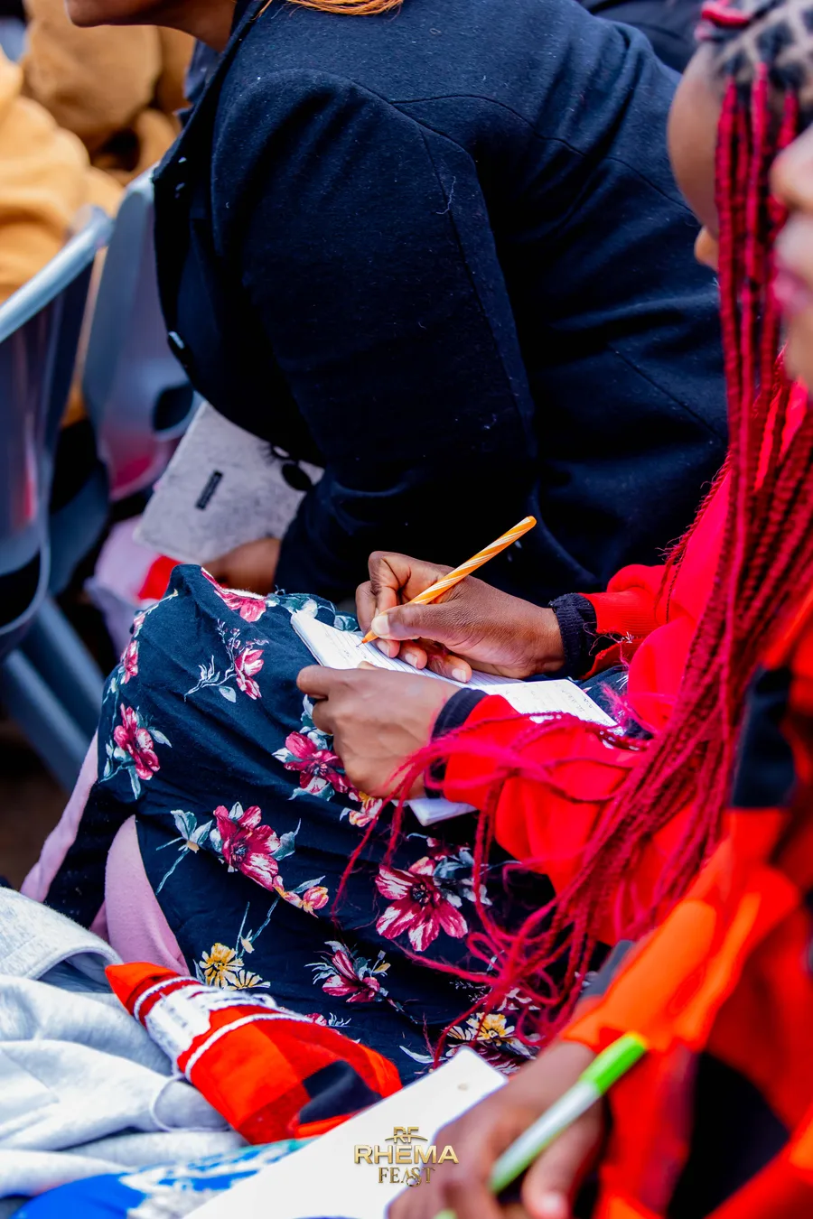 A delegate writing in a notebook during the session