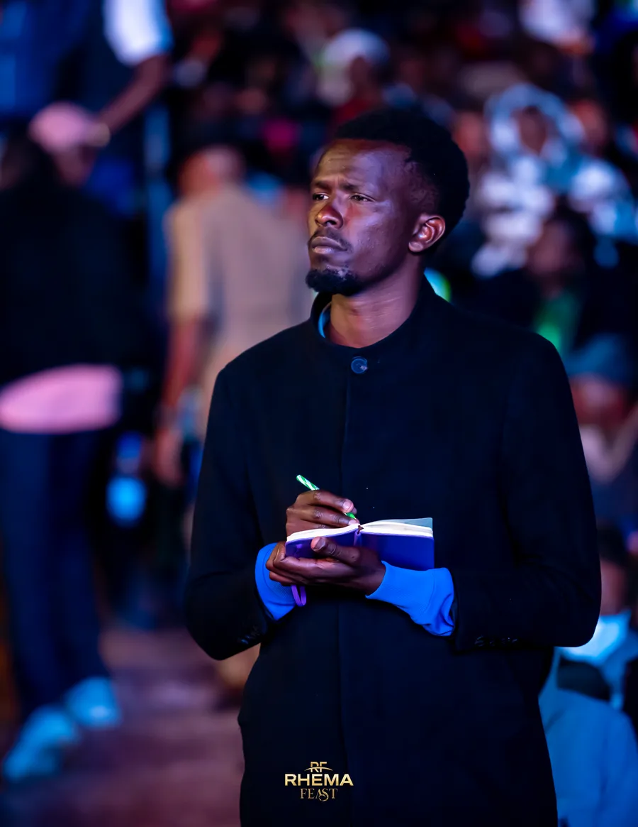 A delegate standing in the dark, writing in a notebook