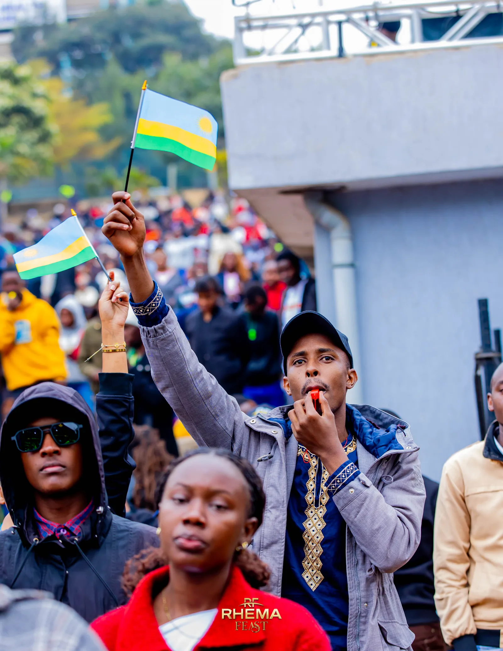 Rwandan flags held up in the crowd at Uhuru Park