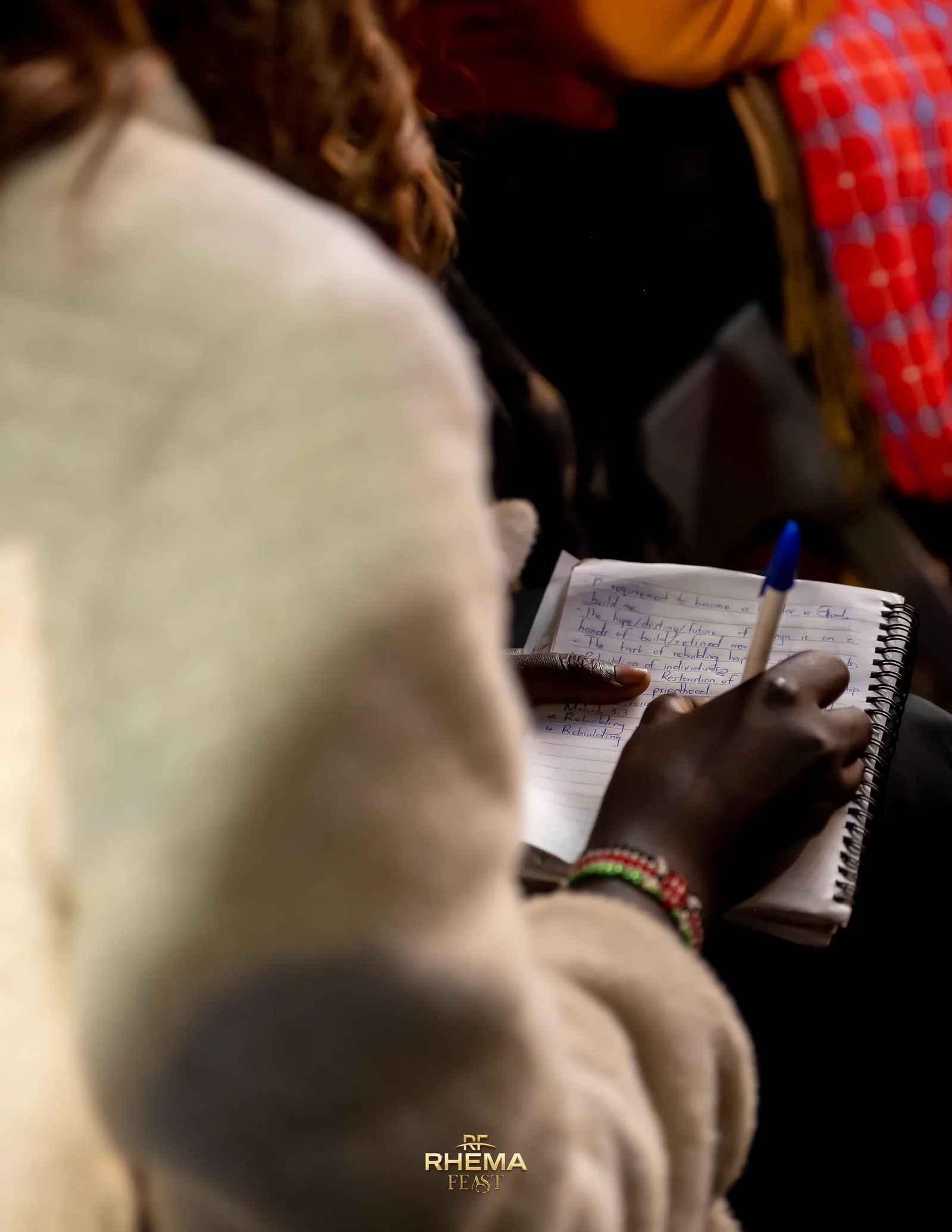 A delegate's open notebook and pen, mid-sentence