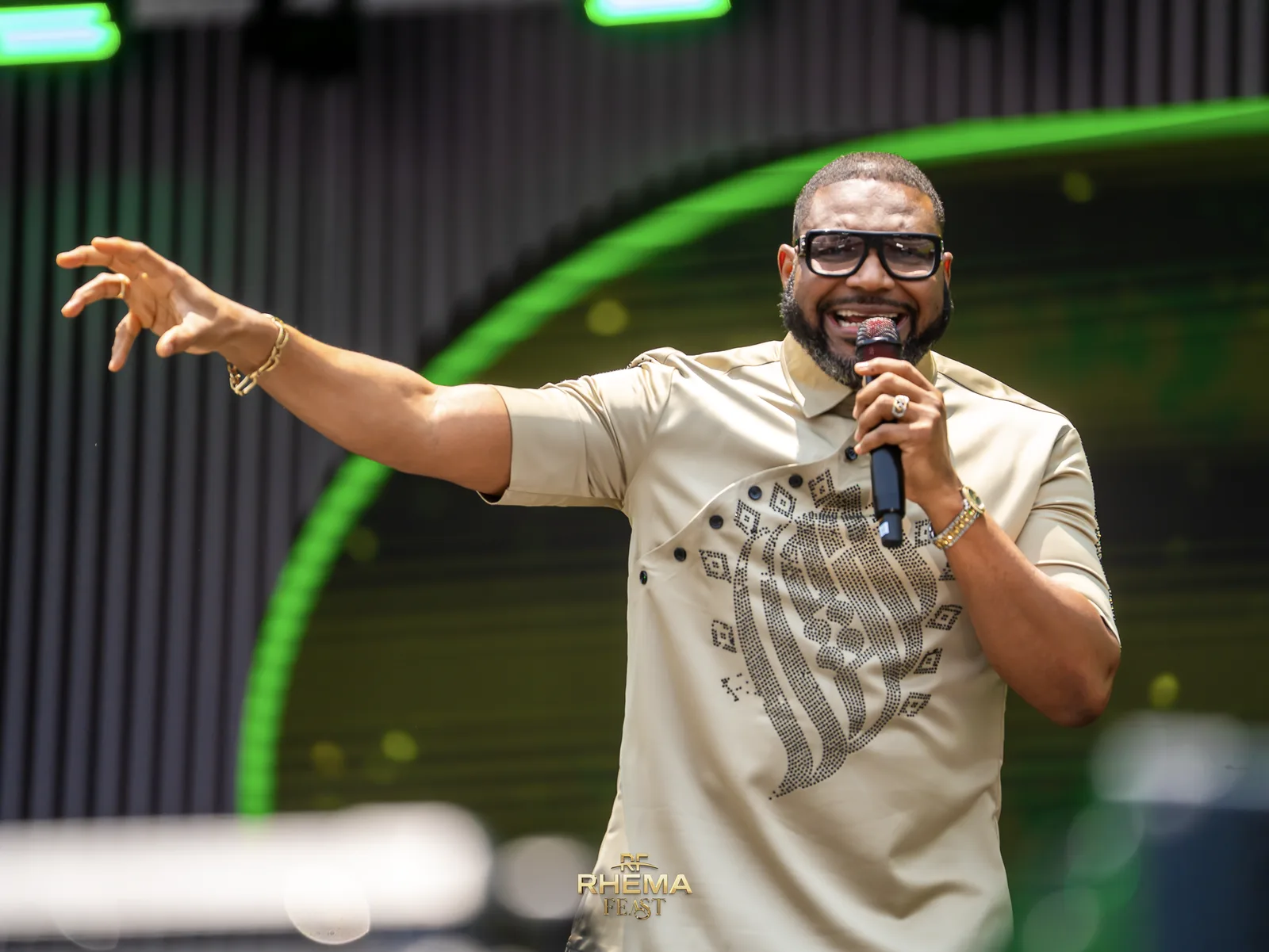 Apostle Felix Okoh with arms open, preaching in daylight