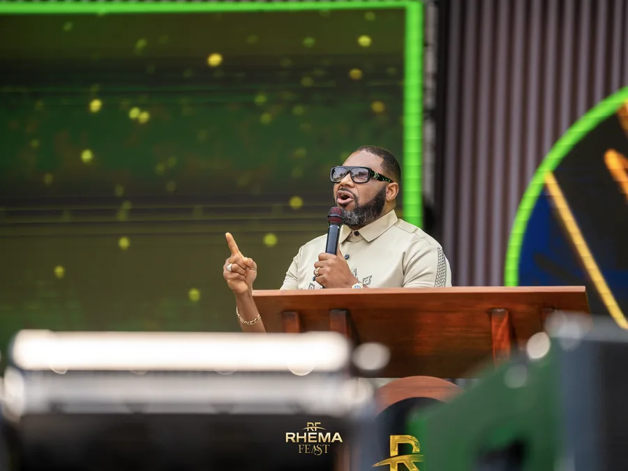 Apostle Felix Okoh with a finger raised, making a point