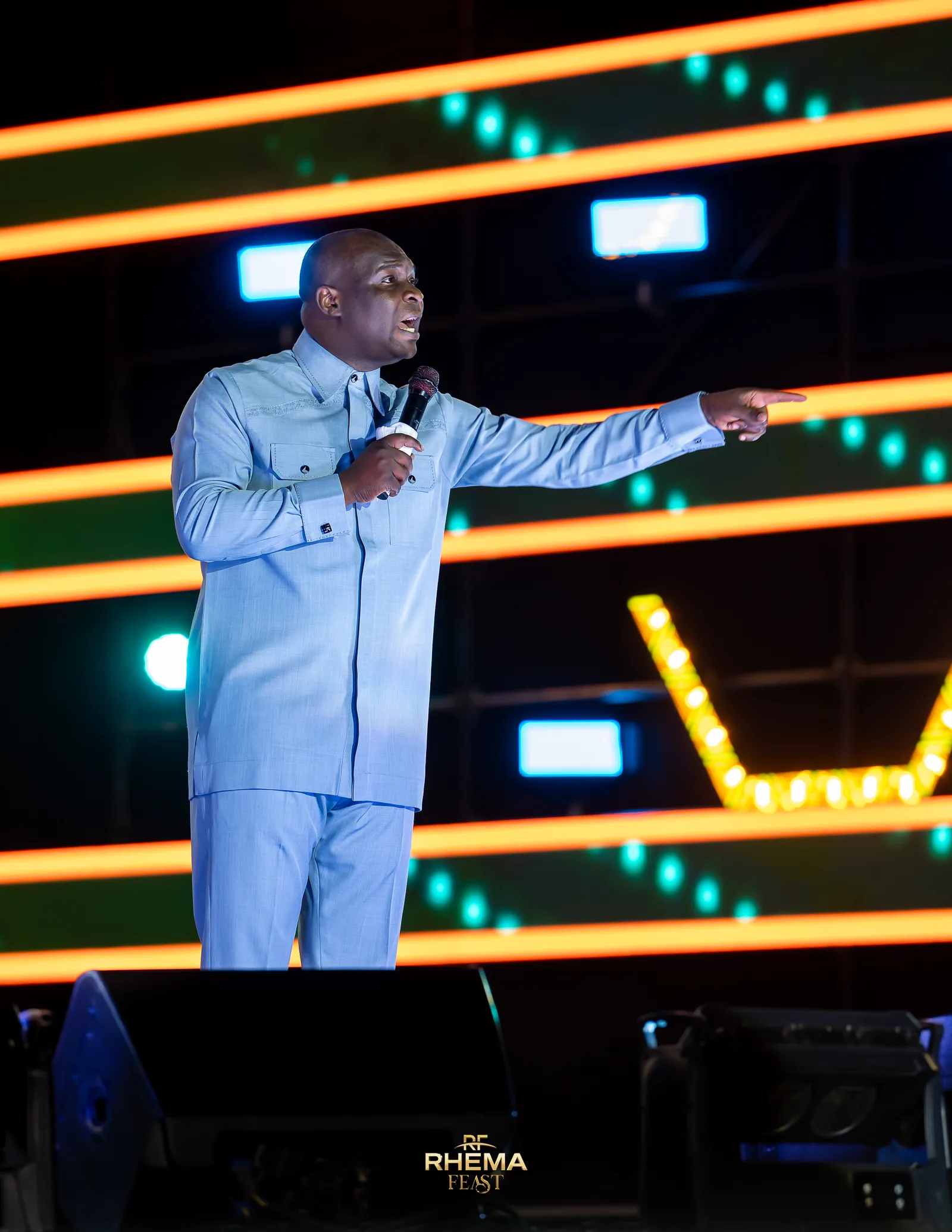 Apostle Joshua Selman with an arm outstretched, preaching