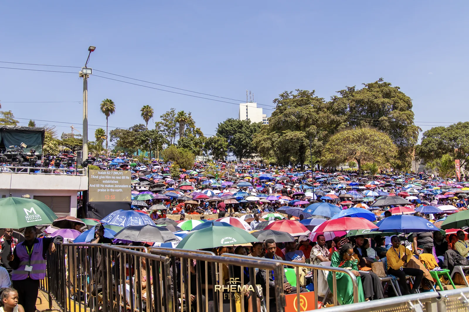 The crowd at Uhuru Park in daylight under a field of umbrellas