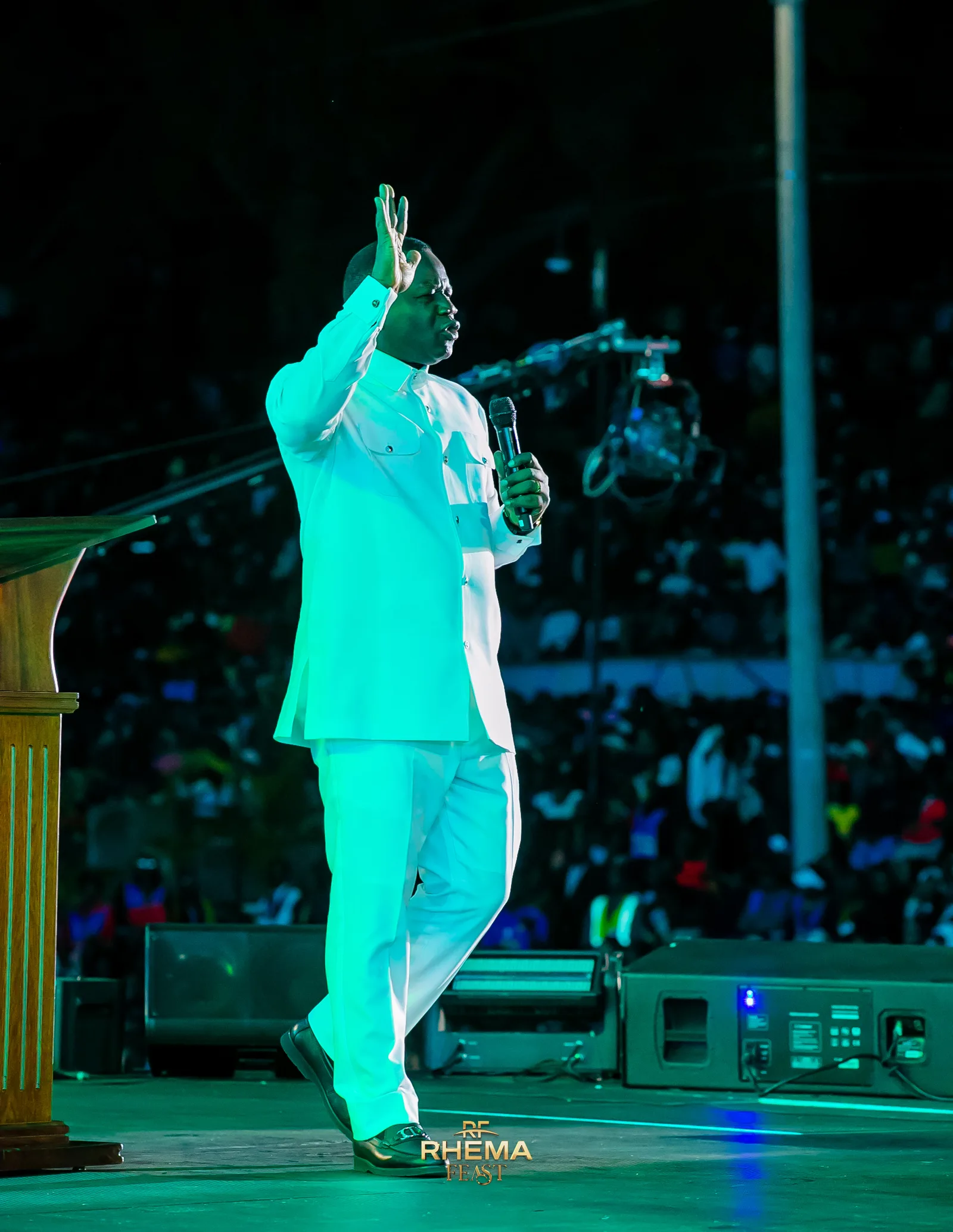 Dr. David Ogbueli preaching with the filled park behind him on Day 5