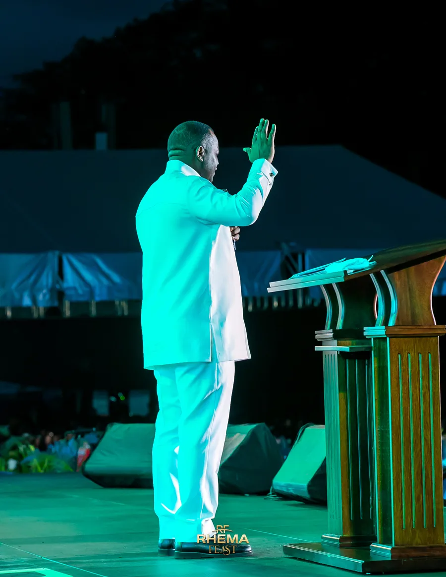 Dr. David Ogbueli with one hand raised at the close of the sermon
