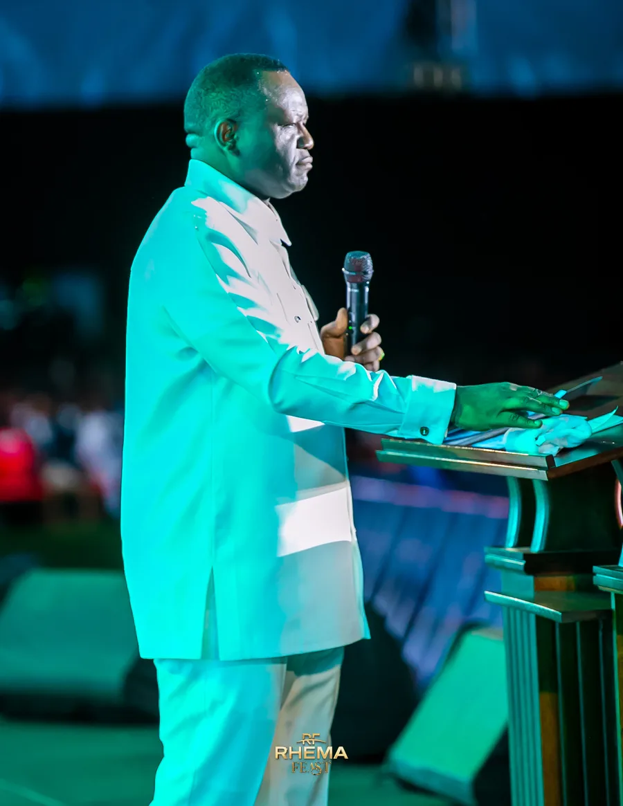 Dr. David Ogbueli leaning on the podium mid-sentence