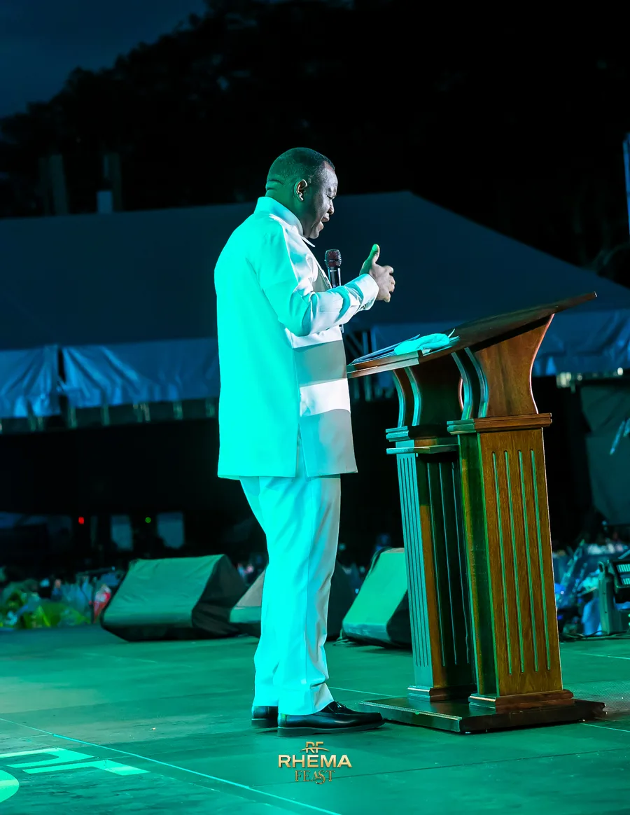 Dr. David Ogbueli at the pulpit with an open Bible