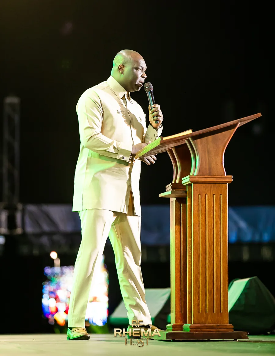 Apostle Joshua Selman reading from the podium