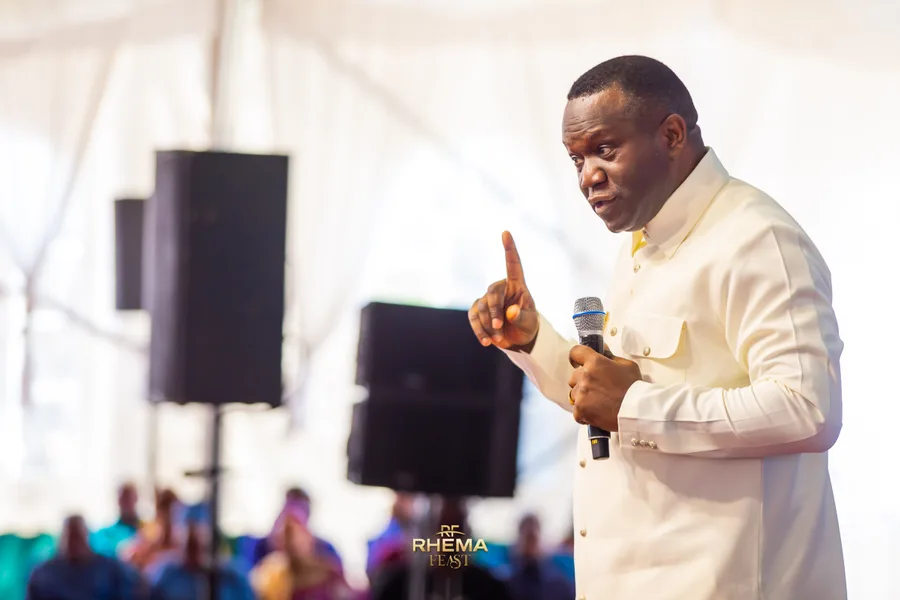 Dr. David Ogbueli making a point with one finger raised